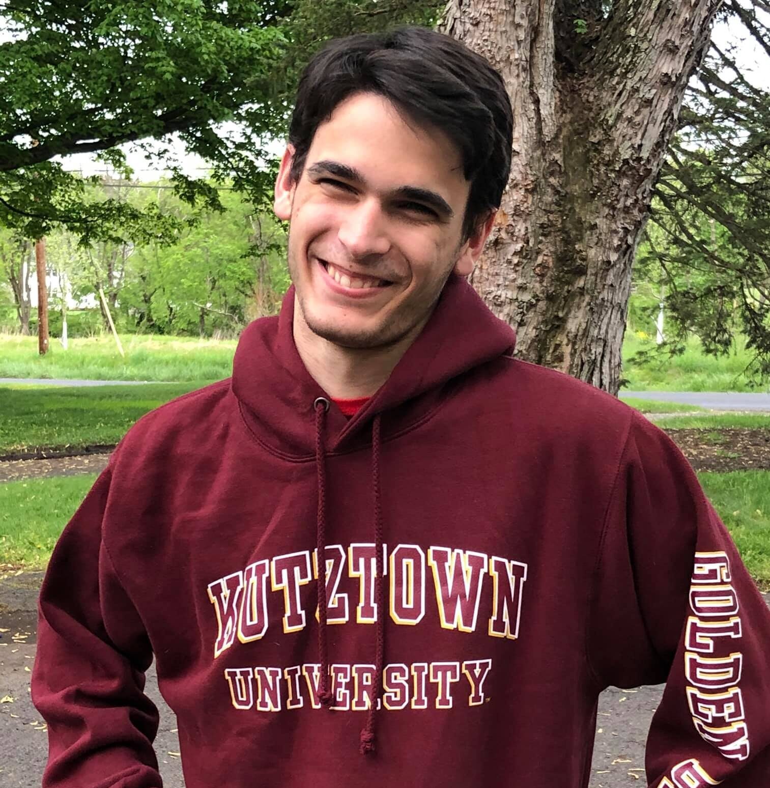 Mitch smiling wearing a kutztown university hoodie
