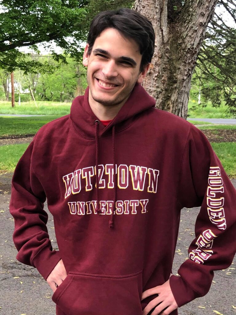 Mitch smiling wearing a kutztown university hoodie